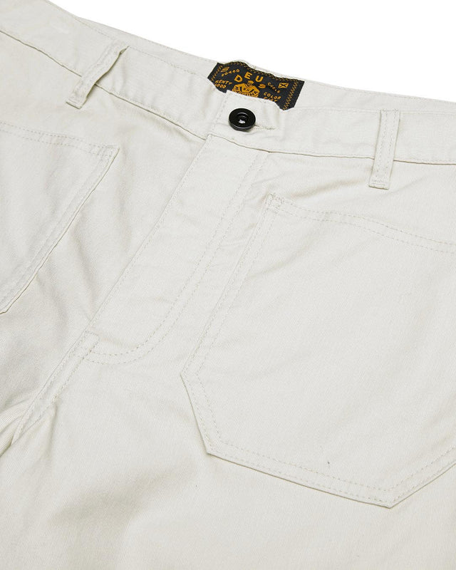 white relaxed slightly tapered fit military pant with deck patch pockets, shank fly opening, woven branded label above back pocket, 100% cotton whipcord fabrication with a heavy enzyme stone wash