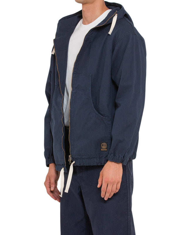 navy relaxed fit parka with elasticated cuffs and adjustable drawstring hem, large front pockets, two way zip opening, wind and rain resistant in a 100% cotton canvas fabrication with dry wax finish